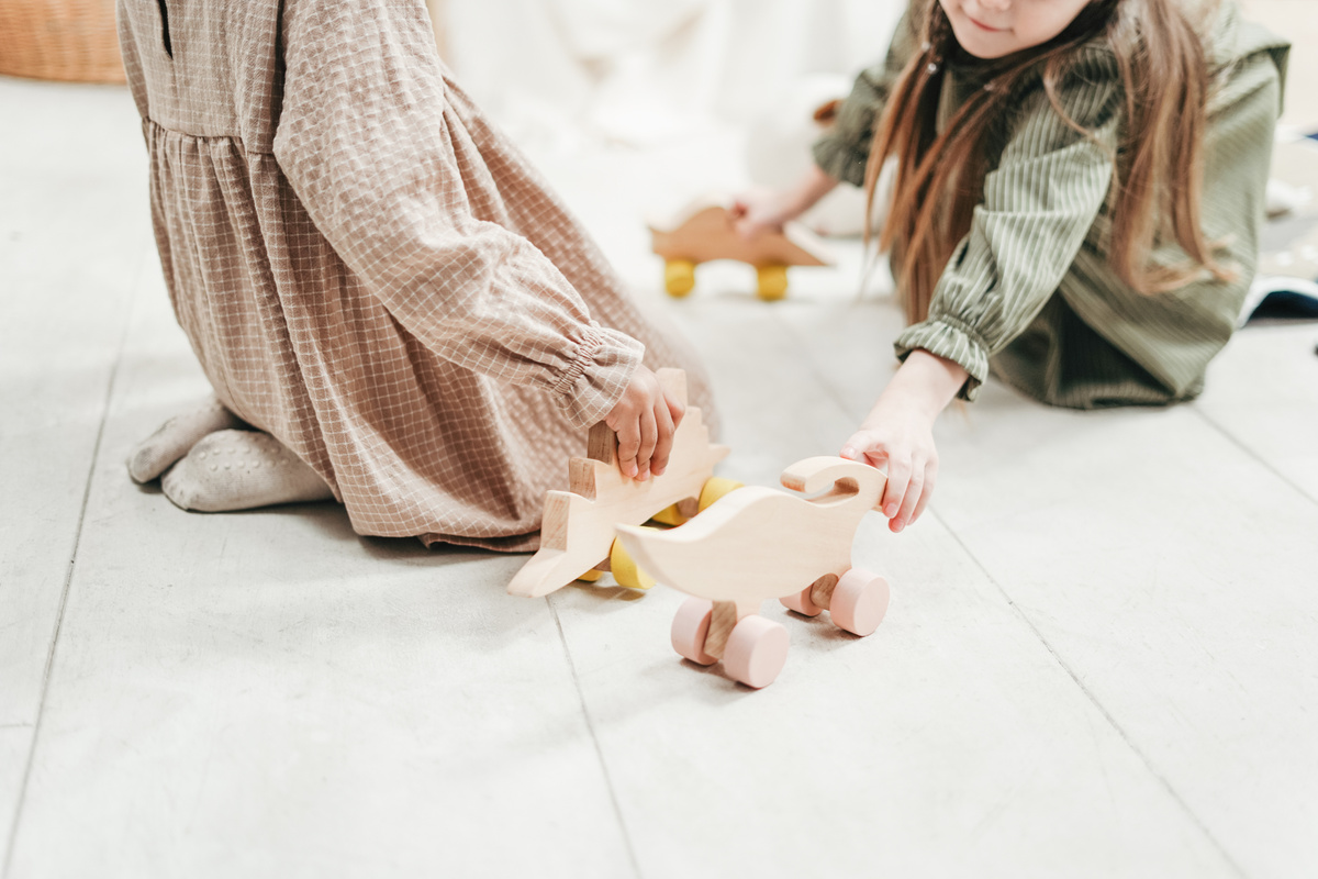 Photo of Two Girls Playing With Wooden Toys